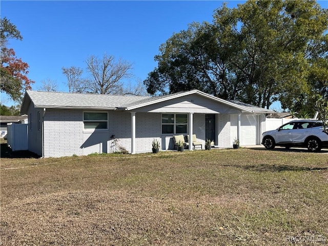 ranch-style home with a garage and a front lawn