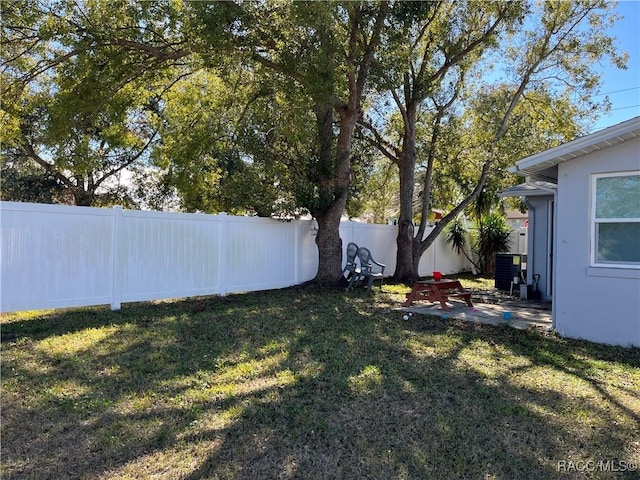 view of yard with a patio area and central air condition unit