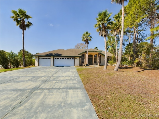 view of front of home with a garage, concrete driveway, and stucco siding