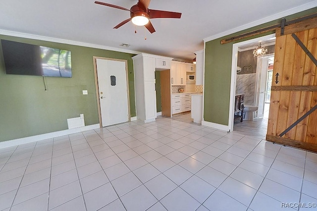 unfurnished living room featuring light tile patterned flooring, crown molding, baseboards, and ceiling fan