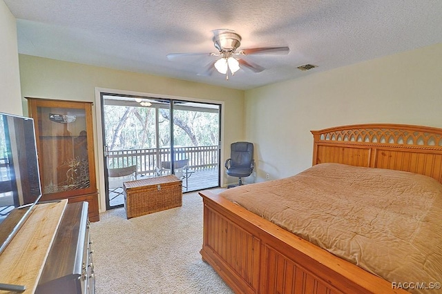 bedroom featuring visible vents, a ceiling fan, light colored carpet, access to exterior, and a textured ceiling