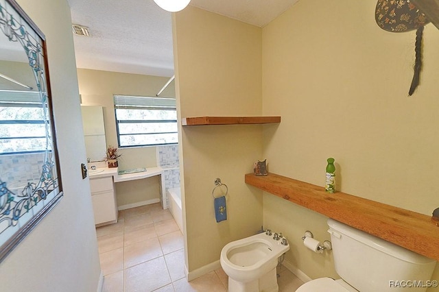 full bath featuring toilet, vanity, baseboards, tile patterned floors, and a bidet