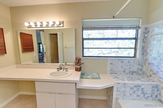 bathroom featuring tile patterned flooring, baseboards, and vanity