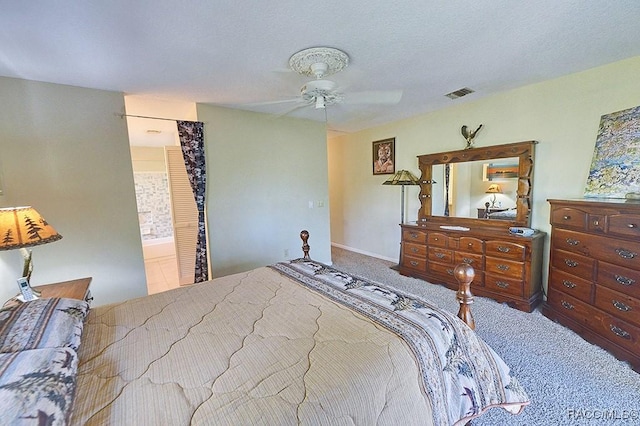 bedroom with carpet floors, ceiling fan, visible vents, and a textured ceiling