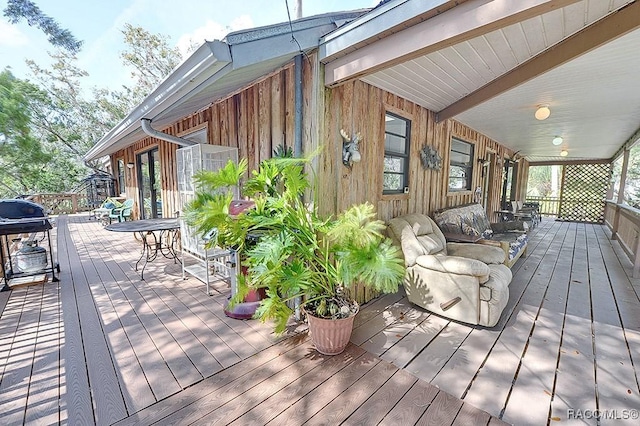 wooden terrace featuring a grill