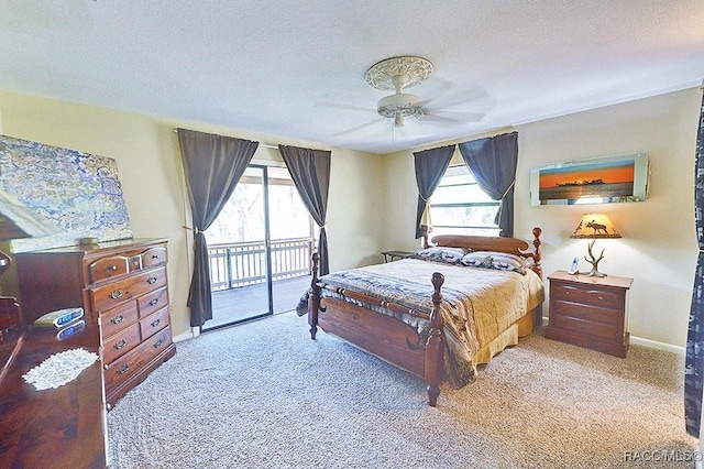 bedroom featuring a textured ceiling, carpet floors, multiple windows, and access to exterior