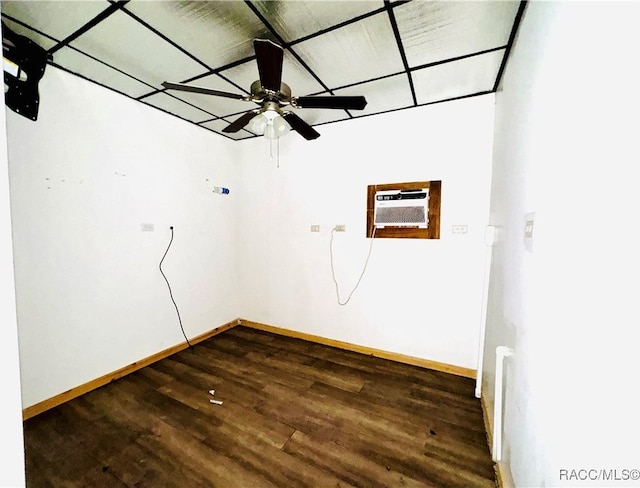 unfurnished room with ceiling fan, dark hardwood / wood-style flooring, and an AC wall unit