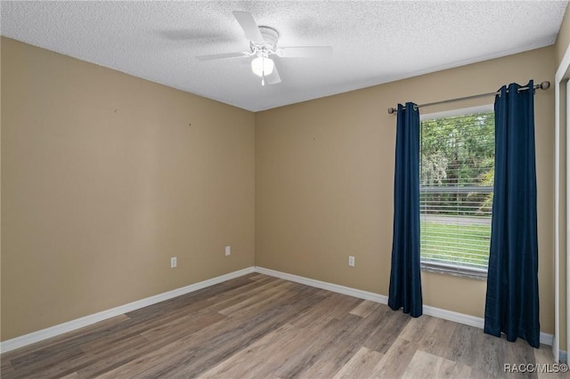 3224 E Davis Ln, Inverness, FL 34453 - empty room featuring wood finished floors, a textured ceiling, and ceiling fan
