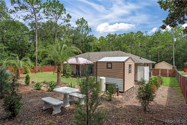3224 E Davis Ln, Inverness, FL 34453 - rear view of property with a fenced backyard and an outdoor structure