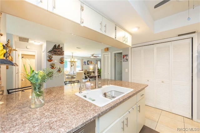 kitchen with light tile patterned flooring, ceiling fan, sink, and white cabinets