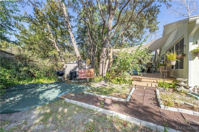 view of yard featuring a wooden deck