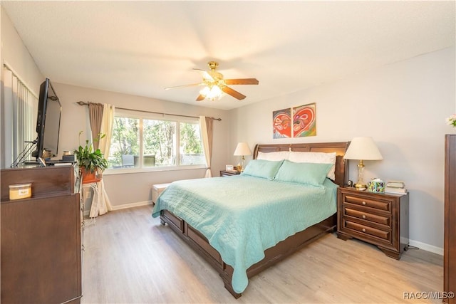 bedroom with ceiling fan and light hardwood / wood-style flooring