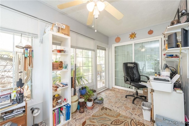 office space with a textured ceiling and ceiling fan