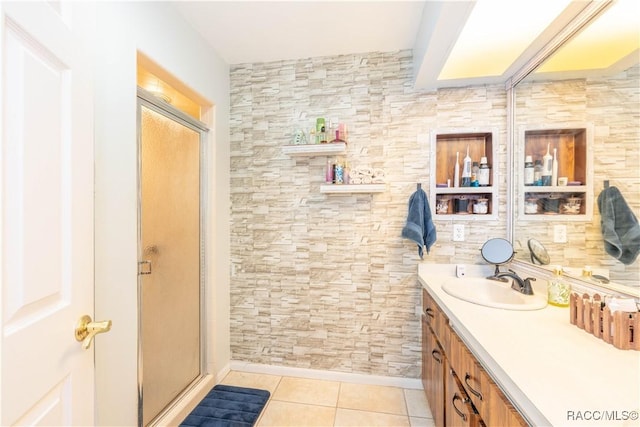 bathroom featuring a shower with door, vanity, and tile patterned floors