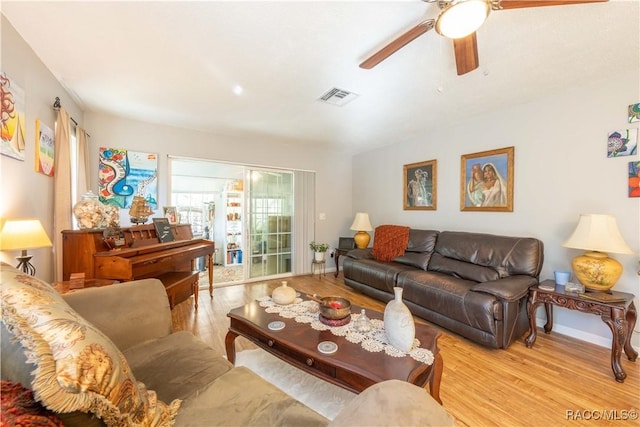 living room featuring ceiling fan and light wood-type flooring