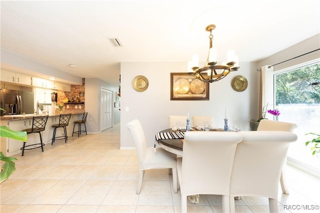 dining room featuring light tile patterned floors and an inviting chandelier