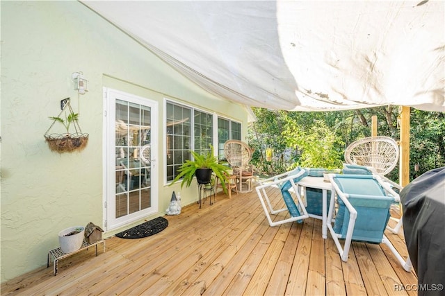 wooden deck featuring a grill