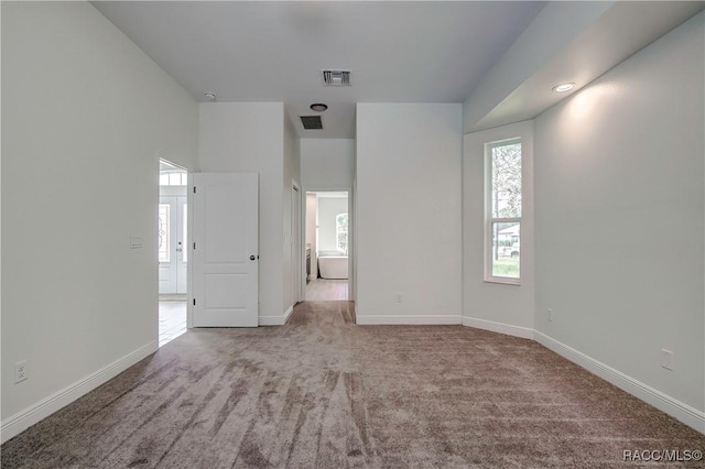 spare room with light colored carpet