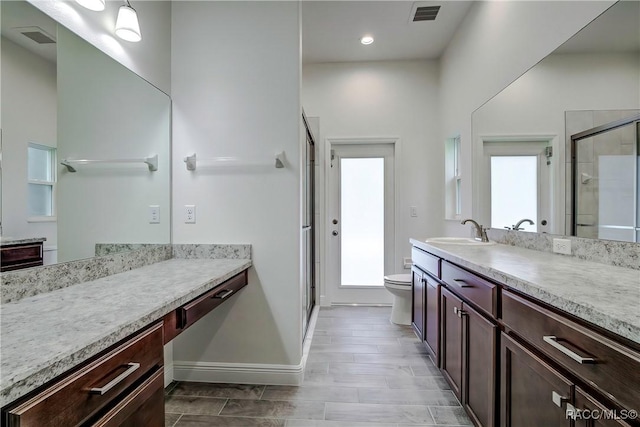 bathroom with vanity, toilet, and walk in shower