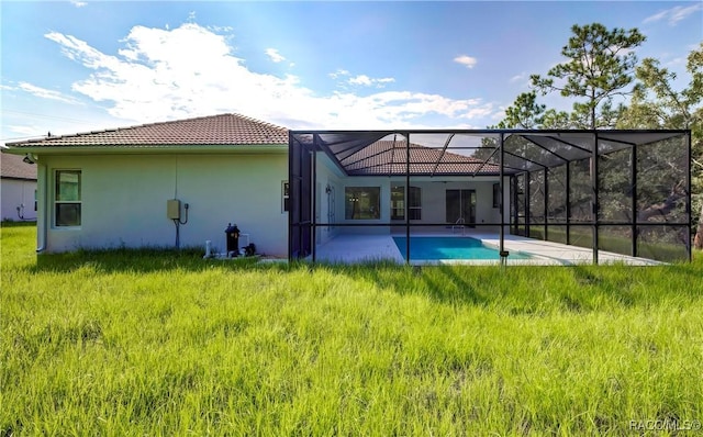 back of property featuring a lanai, a yard, and a patio