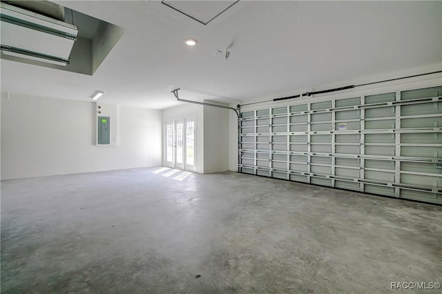 garage with electric panel and french doors