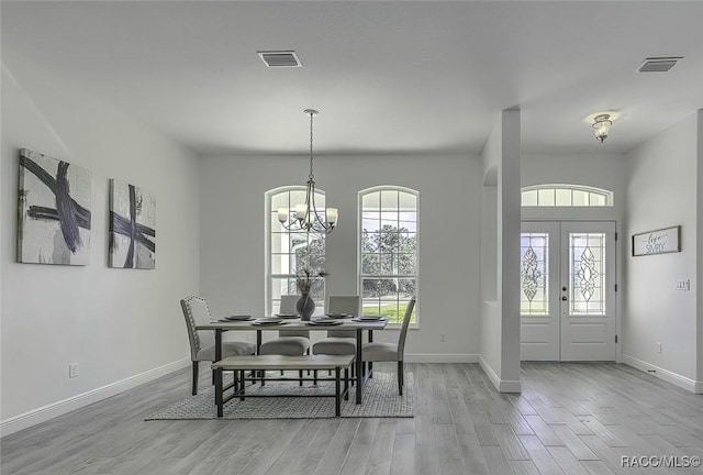 dining room with a chandelier and light hardwood / wood-style floors