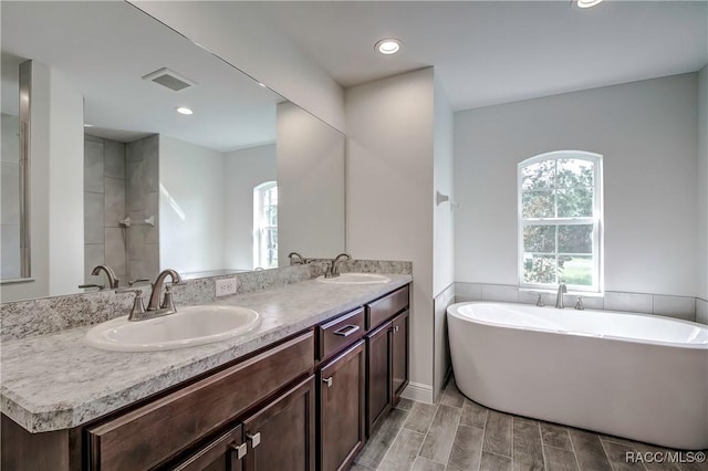 bathroom featuring a tub and vanity