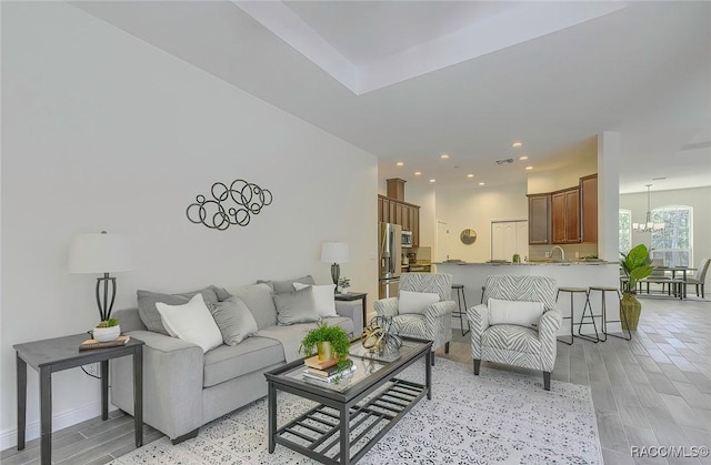 living room featuring a notable chandelier