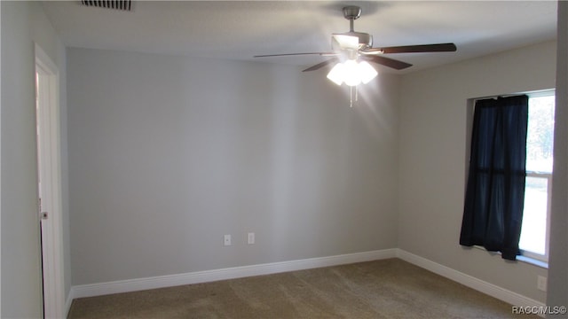 carpeted empty room featuring ceiling fan