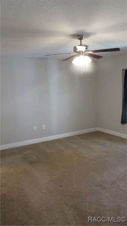 empty room with ceiling fan, carpet floors, and a textured ceiling