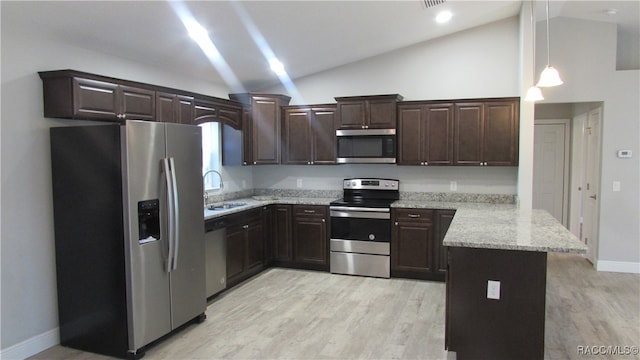 kitchen featuring kitchen peninsula, dark brown cabinetry, decorative light fixtures, and appliances with stainless steel finishes