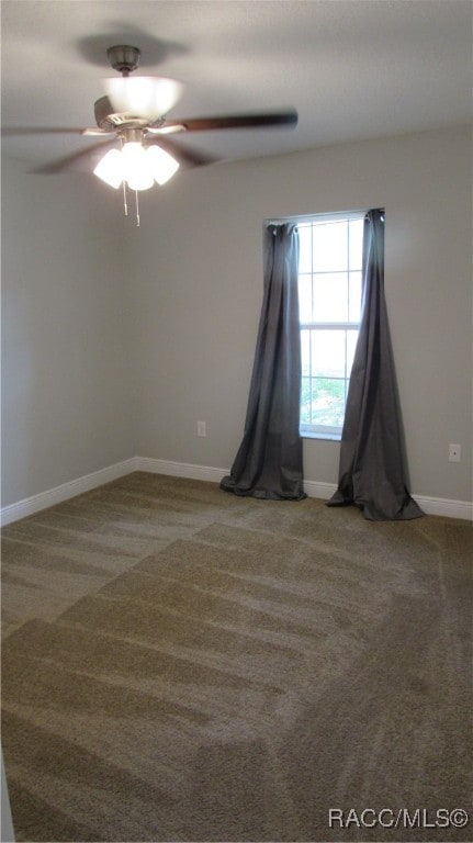 carpeted spare room featuring ceiling fan