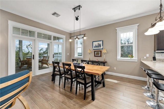 14211 W Saint Martins Rd, Crystal River, FL 34429 - dining area with light wood-style floors, baseboards, crown molding, and visible vents