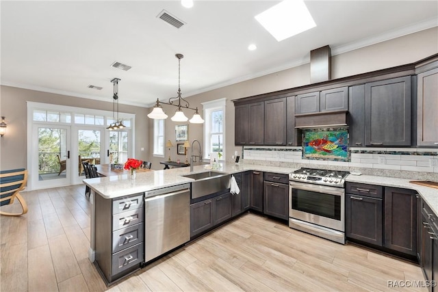 14211 W Saint Martins Rd, Crystal River, FL 34429 - kitchen with a sink, visible vents, a peninsula, and stainless steel appliances
