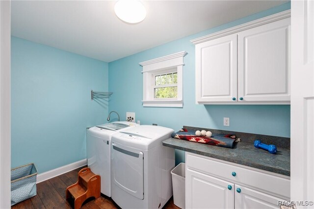 14211 W Saint Martins Rd, Crystal River, FL 34429 - laundry room featuring dark wood-type flooring, washing machine and clothes dryer, baseboards, and cabinet space