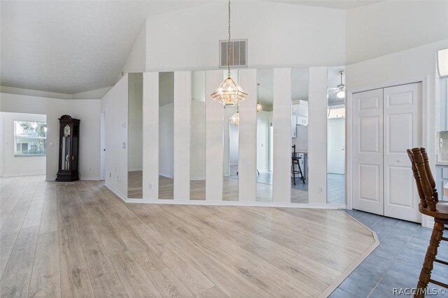 820 Inverie Dr, Inverness, FL 34453 - unfurnished dining area featuring high vaulted ceiling, light wood finished floors, and baseboards