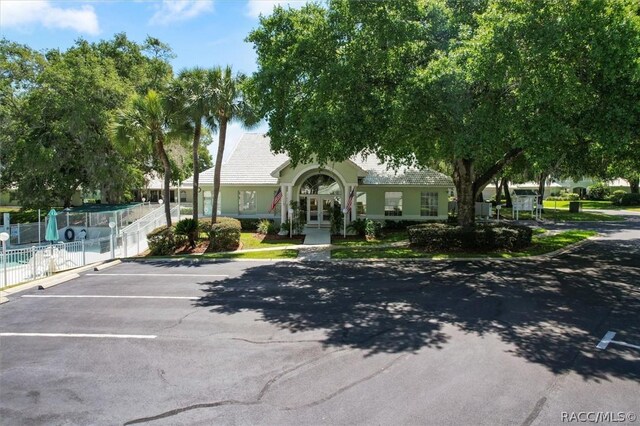 820 Inverie Dr, Inverness, FL 34453 - view of front of house featuring uncovered parking, french doors, and stucco siding