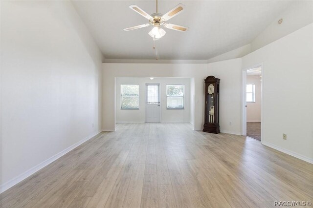 820 Inverie Dr, Inverness, FL 34453 - unfurnished room featuring plenty of natural light, light wood finished floors, ceiling fan, lofted ceiling, and baseboards