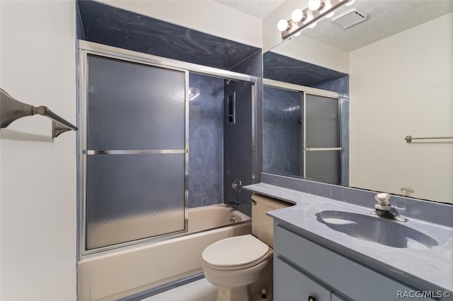 full bathroom featuring a textured ceiling, vanity, shower / bath combination with glass door, tile patterned flooring, and toilet