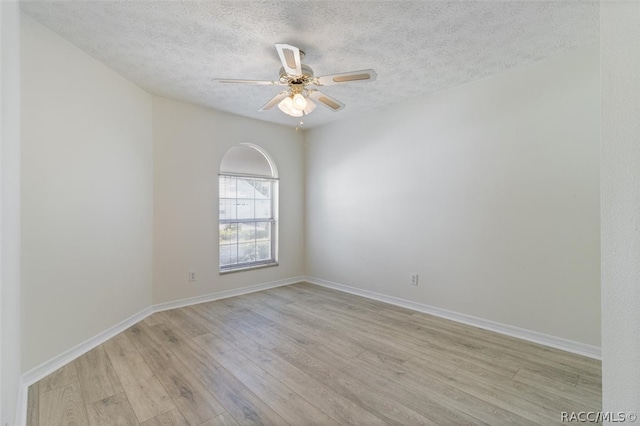 unfurnished room with ceiling fan, a textured ceiling, and light hardwood / wood-style flooring