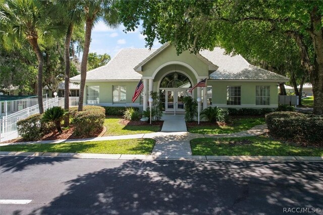 820 Inverie Dr, Inverness, FL 34453 - view of front of home with french doors, stucco siding, and a tiled roof