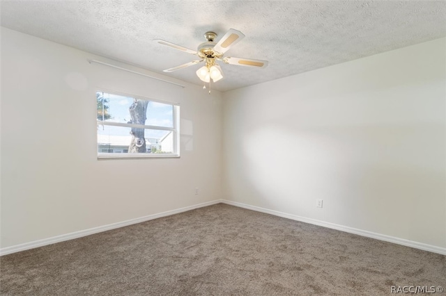 carpeted spare room featuring a textured ceiling and ceiling fan