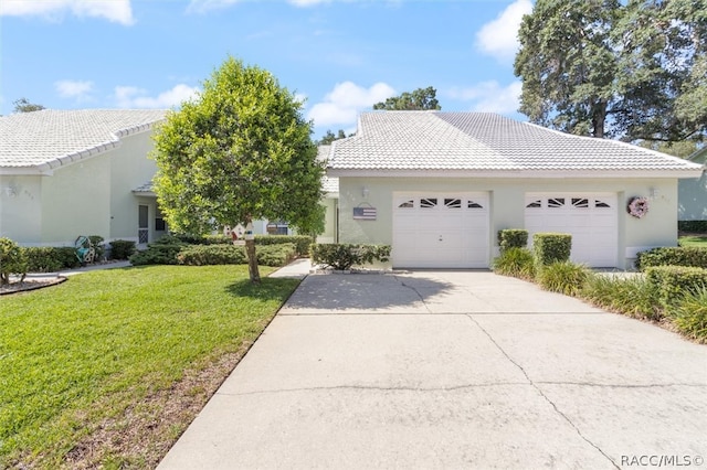 view of front of home featuring a front yard and a garage