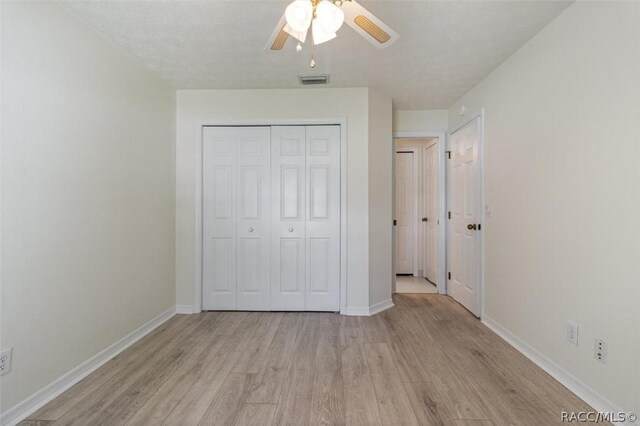 820 Inverie Dr, Inverness, FL 34453 - unfurnished bedroom featuring light wood-style flooring, baseboards, a closet, and ceiling fan