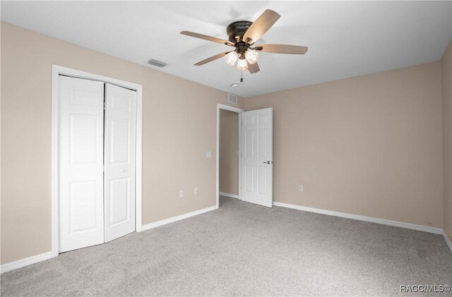 835 N Rembrandt Way, Inverness, FL 34453 - unfurnished bedroom with carpet, a closet, and a ceiling fan
