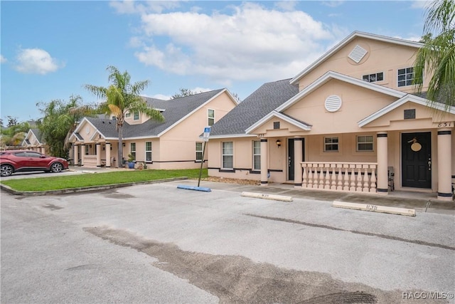 835 N Rembrandt Way, Inverness, FL 34453 - view of front facade with uncovered parking, stucco siding, roof with shingles, and covered porch