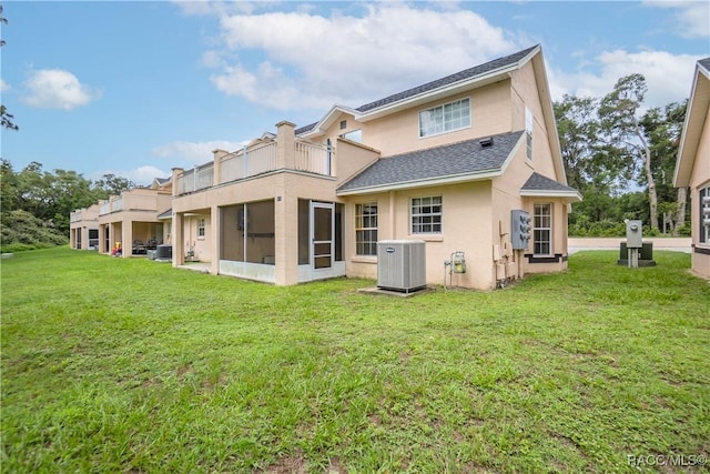 835 N Rembrandt Way, Inverness, FL 34453 - back of property with stucco siding, roof with shingles, a balcony, and a yard