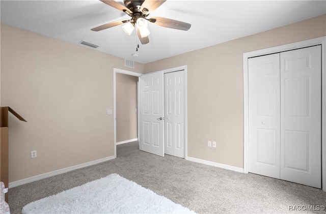 835 N Rembrandt Way, Inverness, FL 34453 - unfurnished bedroom featuring multiple closets, carpet, and a ceiling fan