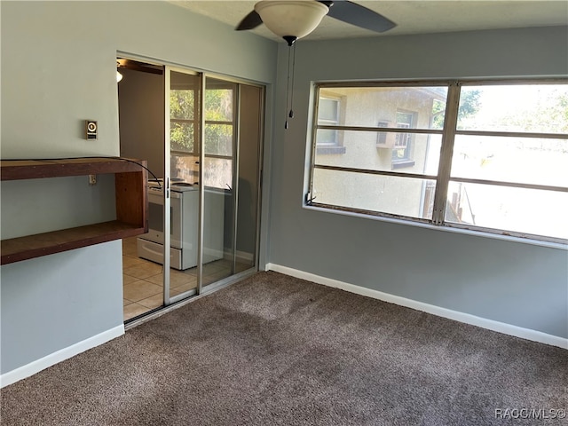 carpeted spare room with ceiling fan