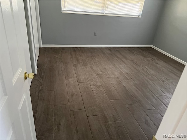 unfurnished room featuring dark hardwood / wood-style floors